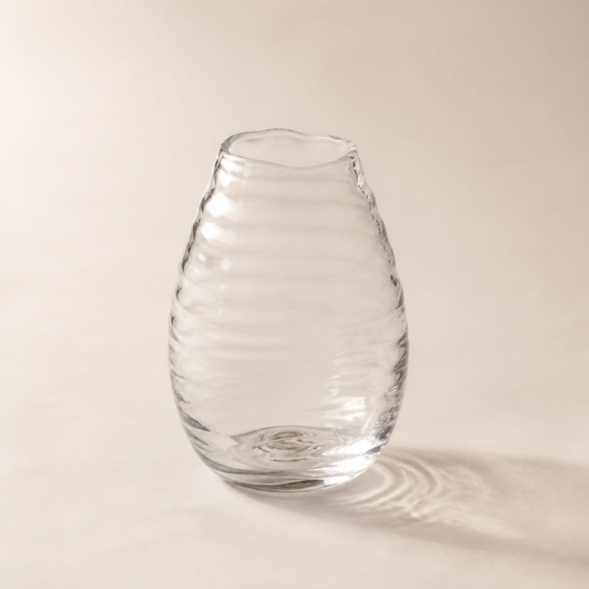 Clear hand-blown glass vase with subtle horizontal ripples
