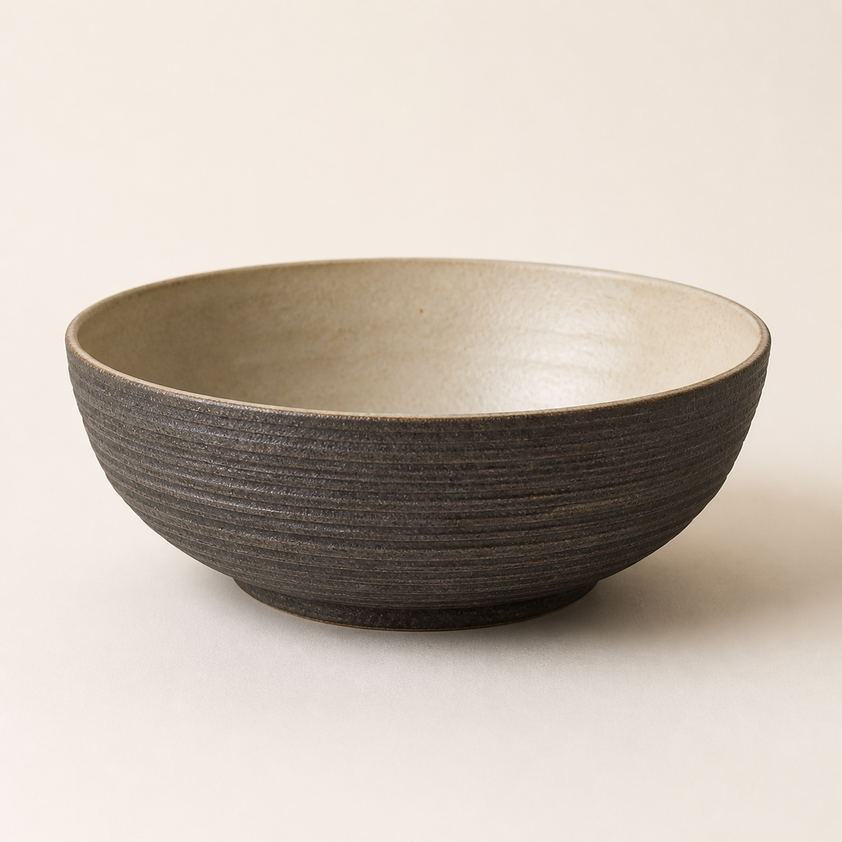 Charcoal ridged stoneware serving bowl with a cream interior