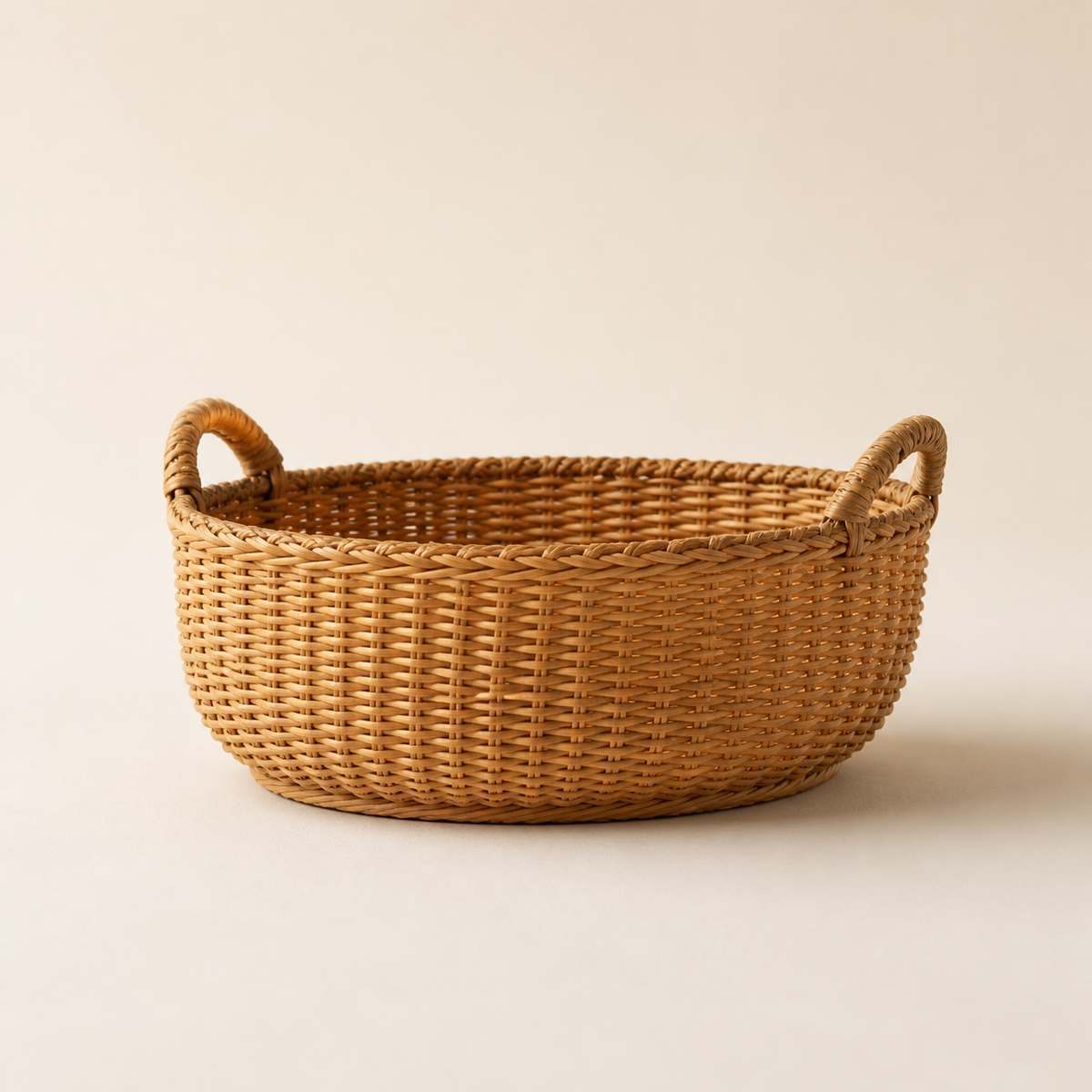 Oval handwoven natural reed basket with two small handles